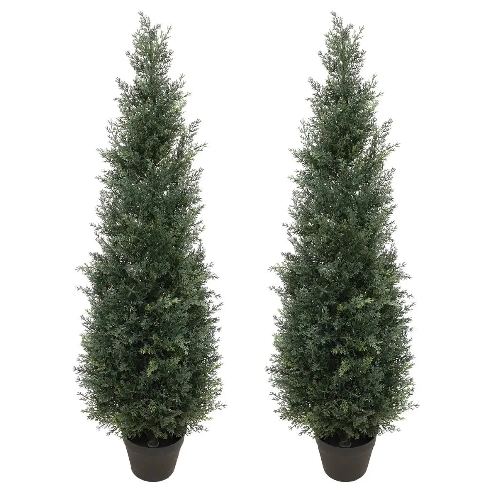 Narrow 4ft artificial cedar topiaries on a small apartment balcony