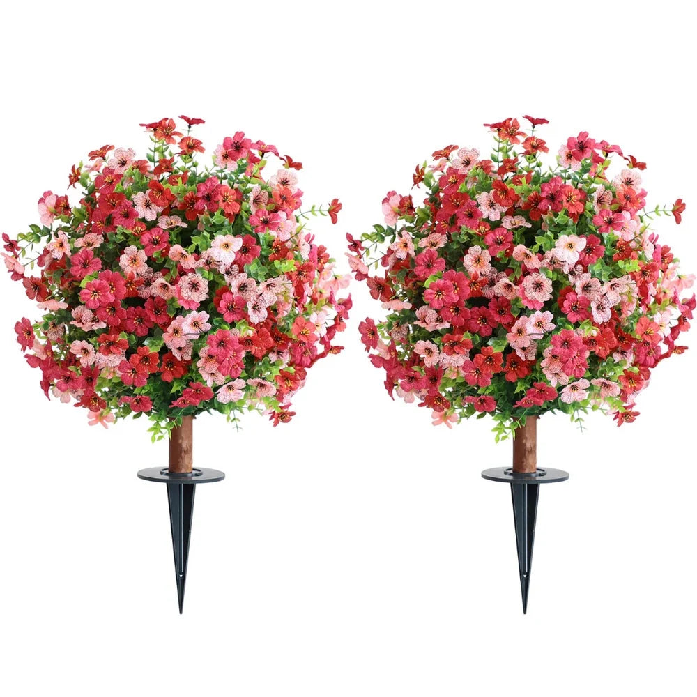 Artificial red and pink mums flower balls in planters beside a front door in autumn