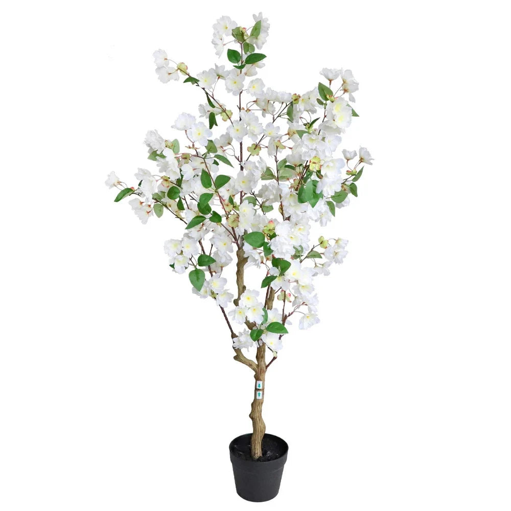 Artificial white cherry blossom trees flanking a wedding ceremony altar